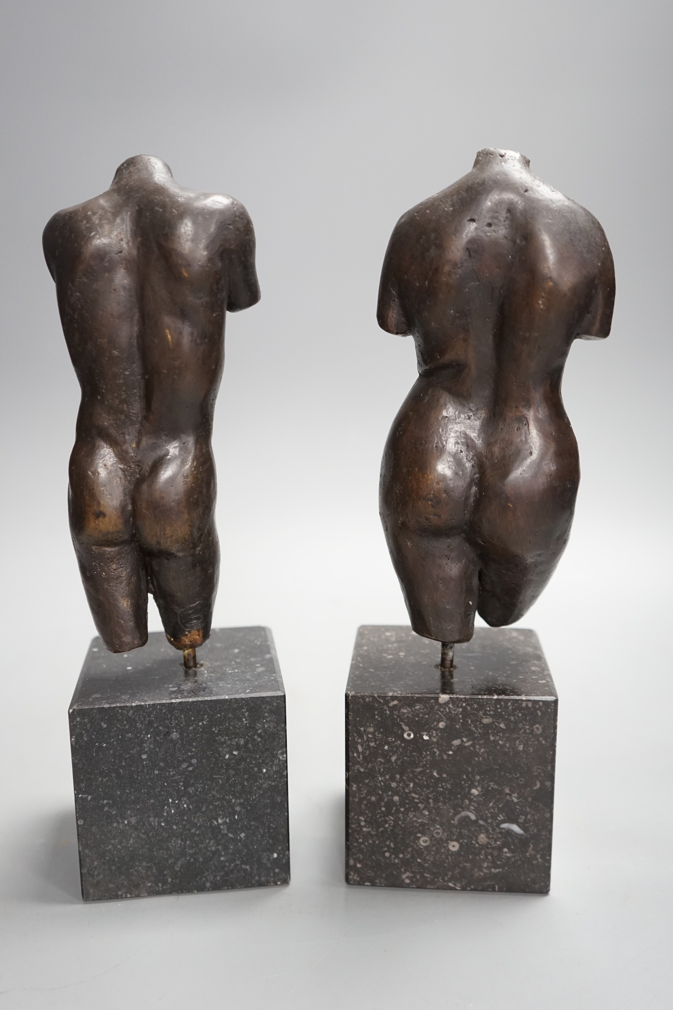 A bronze male and a female nude torso on stand (2), 27cms high